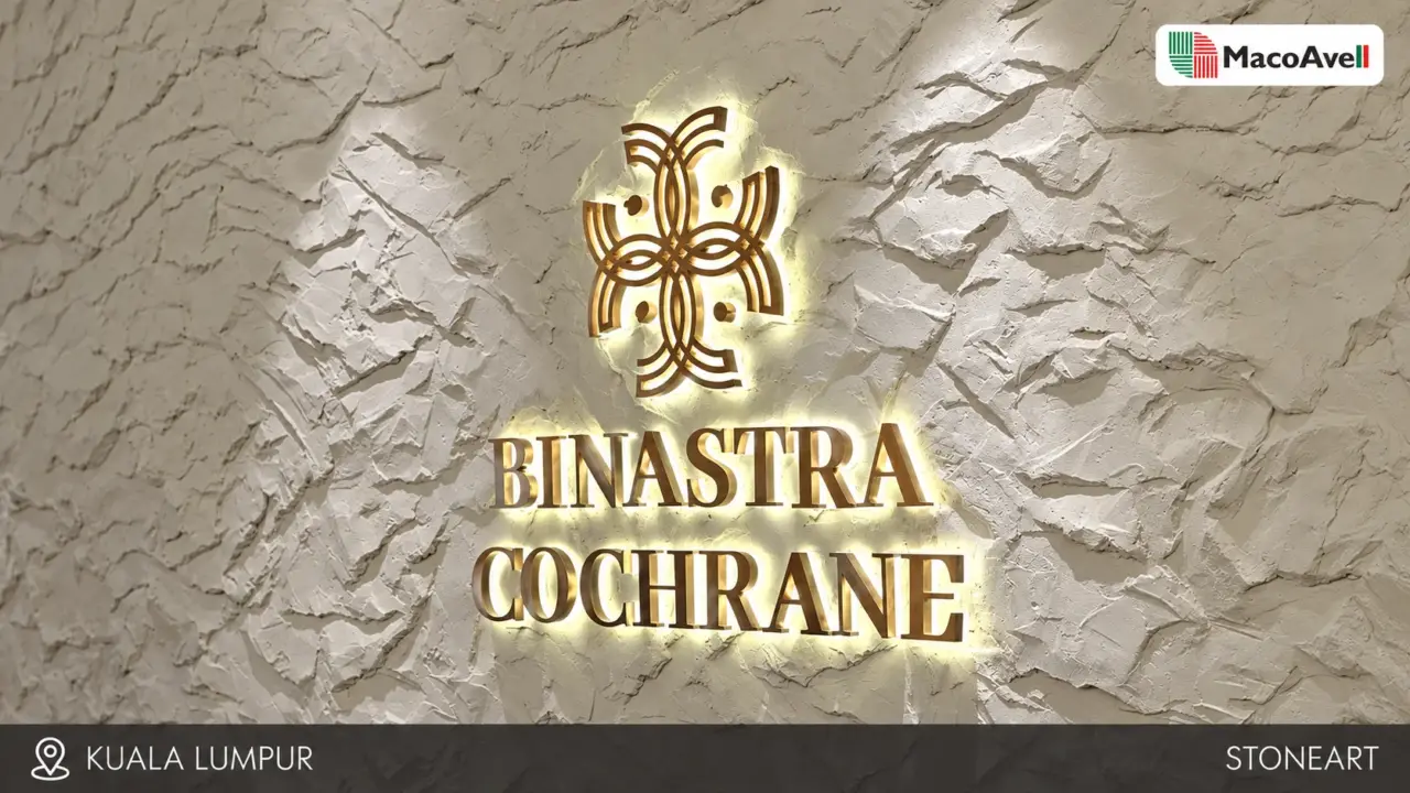 Pale StoneArt feature wall in Kuala Lumpur with raised stone-like texture and illuminated Binastra Cochrane signage.