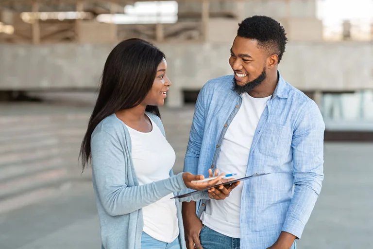 black-female-volunteer-conducting-survey-with-youn-4XLWP4Q
