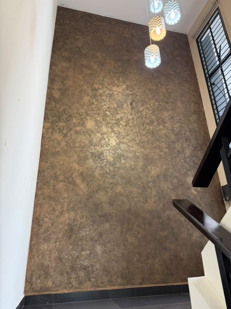 Vellcco Custom Black with Gold Wax staircase feature wall in Klang, with pendant lights and a dark handrail.