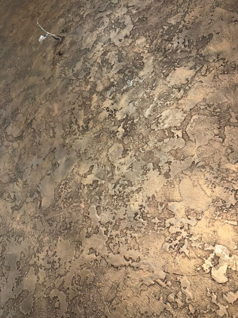 Close-up of Vellcco textured relief in Custom Black with Gold Wax at the Klang project.