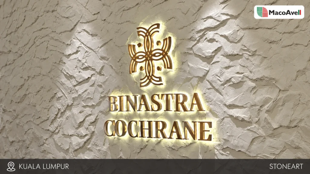 Pale StoneArt feature wall in Kuala Lumpur with raised stone-like texture and illuminated Binastra Cochrane signage.