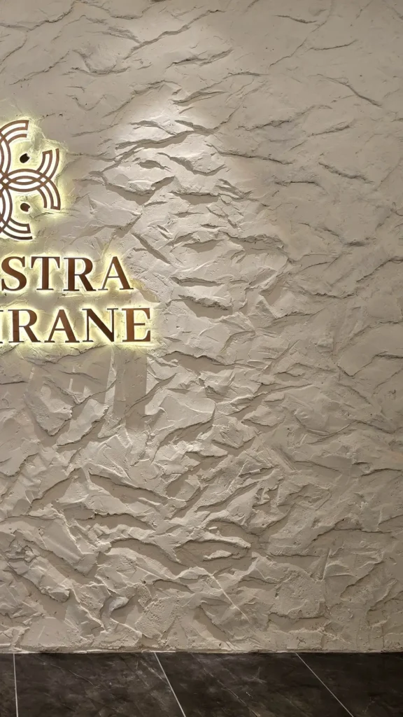 StoneArt surface relief showing irregular overlapping shapes and grey shadows at the Kuala Lumpur feature wall.