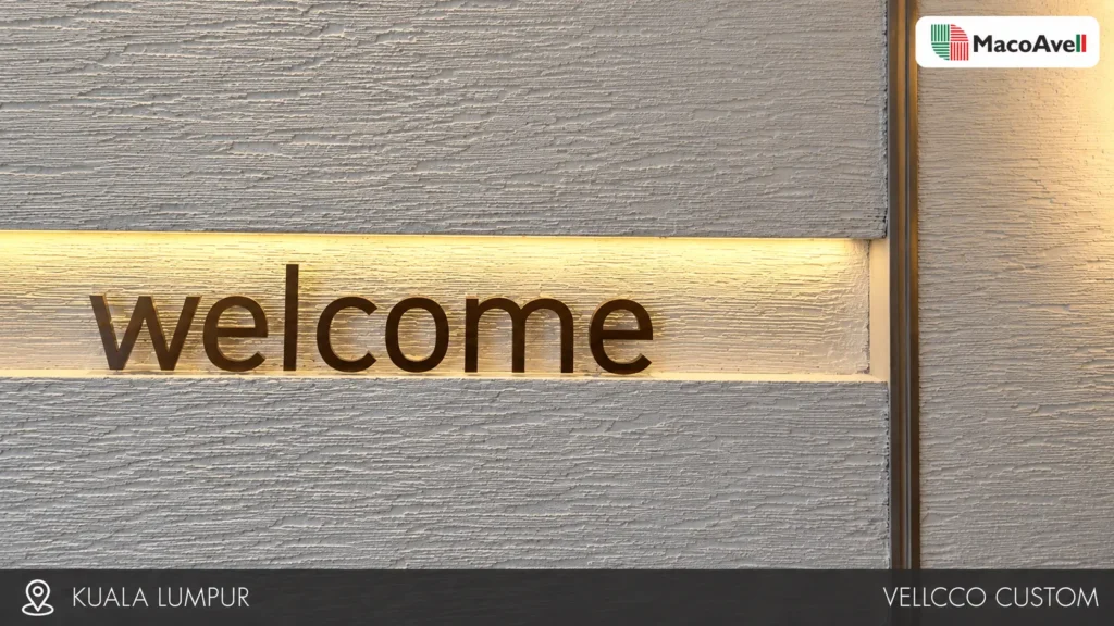 Vellcco Custom welcome wall in Kuala Lumpur, with horizontal texture and warm niche lighting.