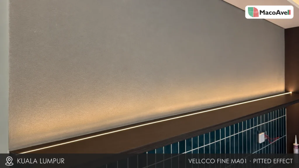 MacoAvell Vellcco Fine MA01 pitted-effect feature wall with warm linear lighting in Kuala Lumpur.