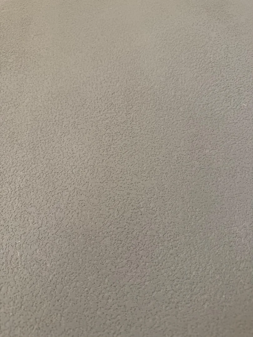 Detailed view of the fine irregular surface pattern in a Vellcco MA01 pitted-effect wall.